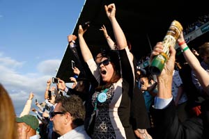 Excited fans cheer on their horse at Saratoga Race Course