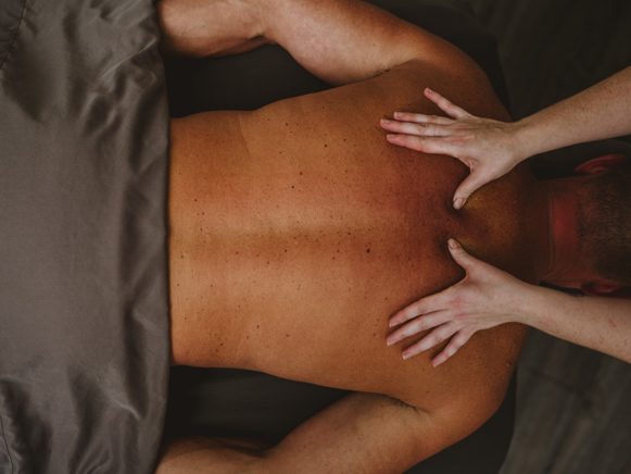 A guest receiving a massage at the Roosevelt Baths & Spa