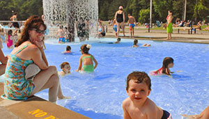 People enjoying a sunny summer day at the pool.