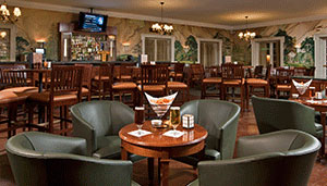 Bar setting with tables and leather arm back chairs.