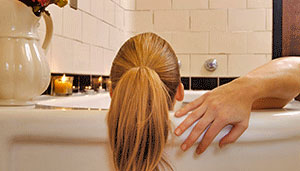 Woman relaxing in a bath tub.